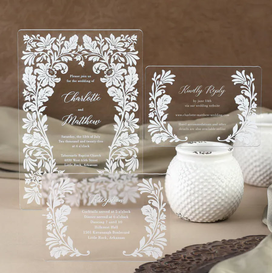 A classic floral design frames the wording on this beautiful acrylic wedding invitation. The crisp look of white ink on clear acrylic brings a touch of modern romance to a timeless design.